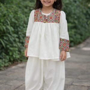 Girl wearing black rayon kurti with white lace detailing and matching palazzo set