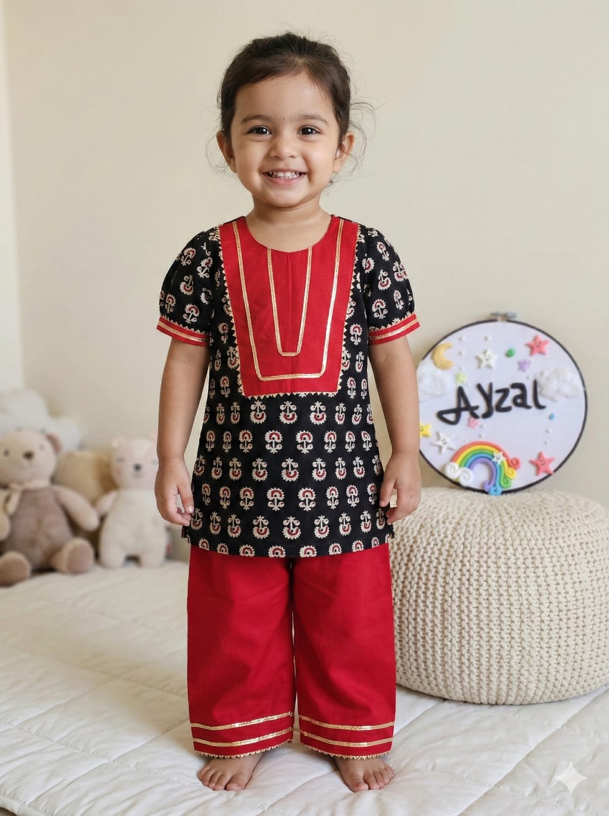 Girls black Ajrakh print cotton kurti with red plazo pants and gota work detailing by Ayzal Kids Wear.