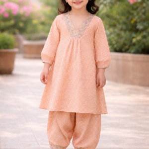Peach rayon girls kurti and pant set with printed design and embroidered neckline.