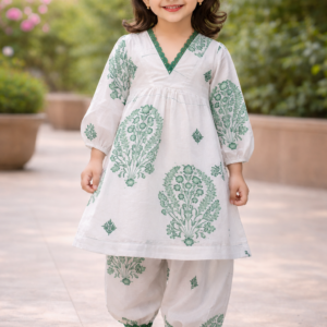White rayon girls kurti and pant set with green floral print and lace neckline detailing.